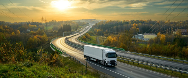 LKW auf Landstraße im Sonnenuntergang